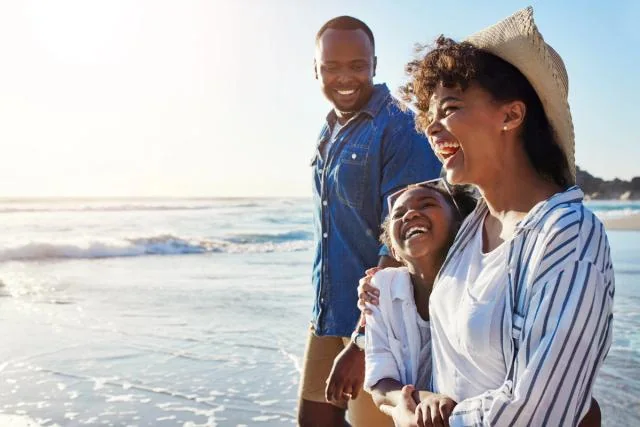 Family smiling together on a beach