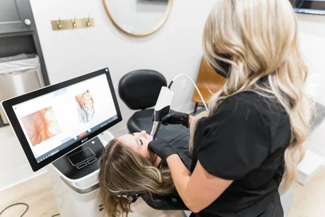 Optimum Dental clinician using digital imaging during cosmetic planning