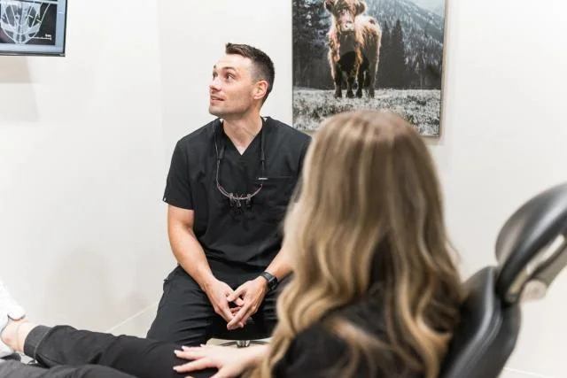 Optimum Dental clinician speaking with a patient about preventive care