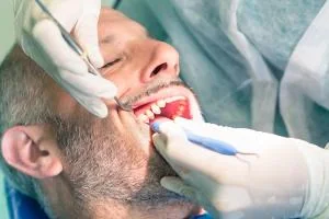 Dental professional providing gum care