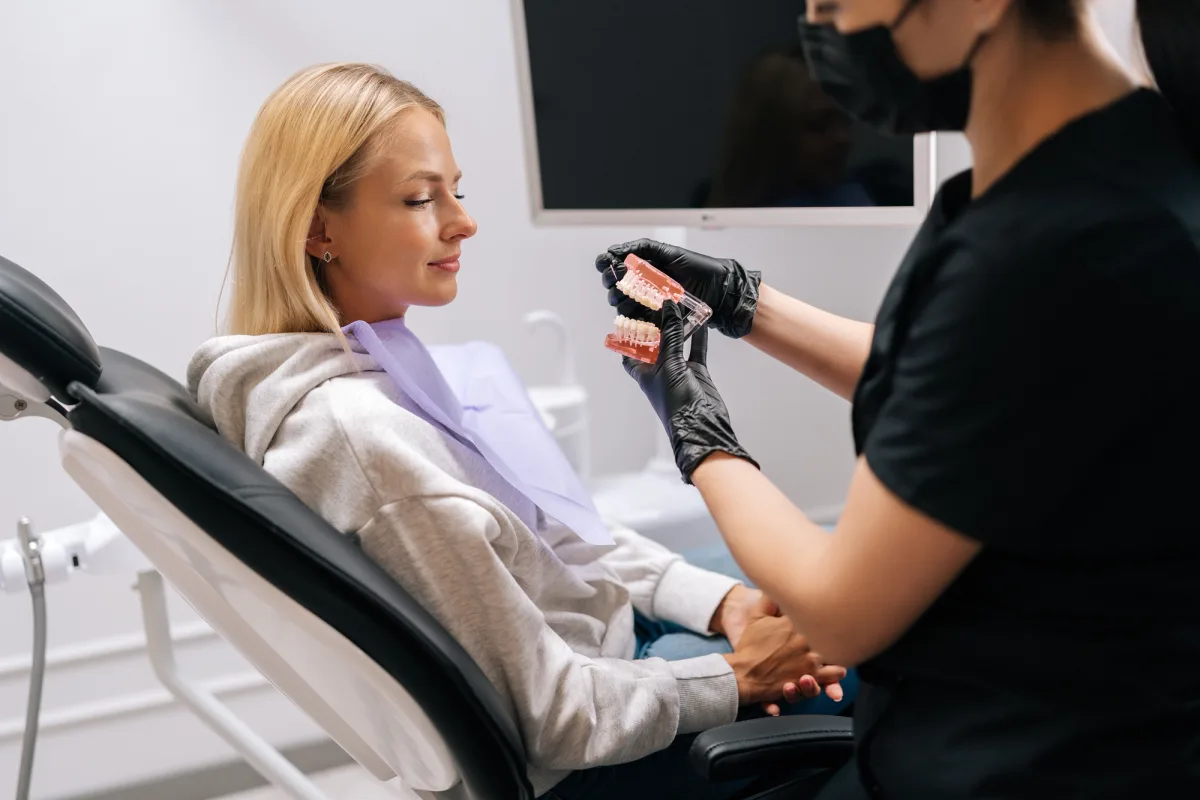 Dental professional explaining restorative treatment options to a patient