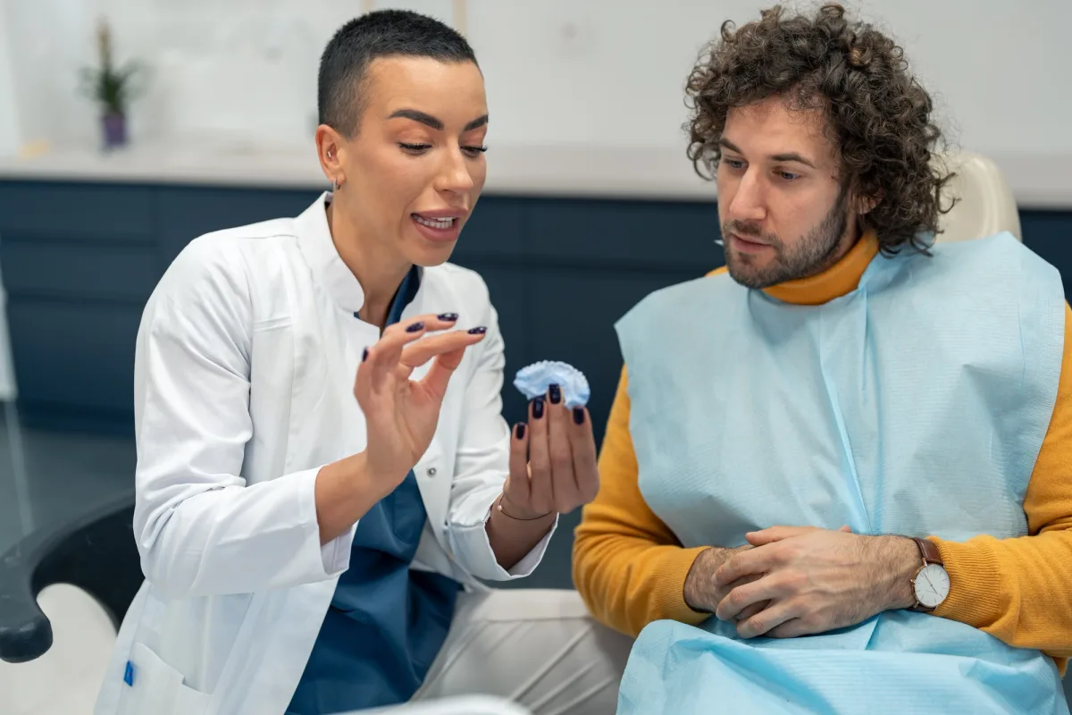Dental clinician explaining a personalized treatment model to a patient